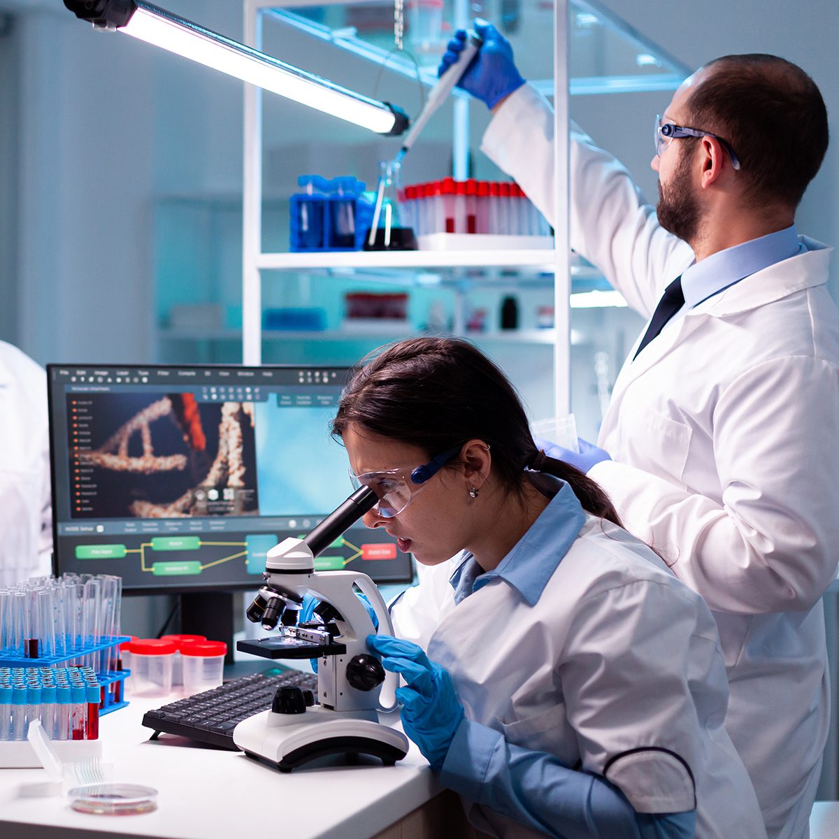 Group of researcher in healthcare laboratory study virus to discover vaccineResearch chemists working in lab with high tech analyzing blood and genetic material samples discovery,